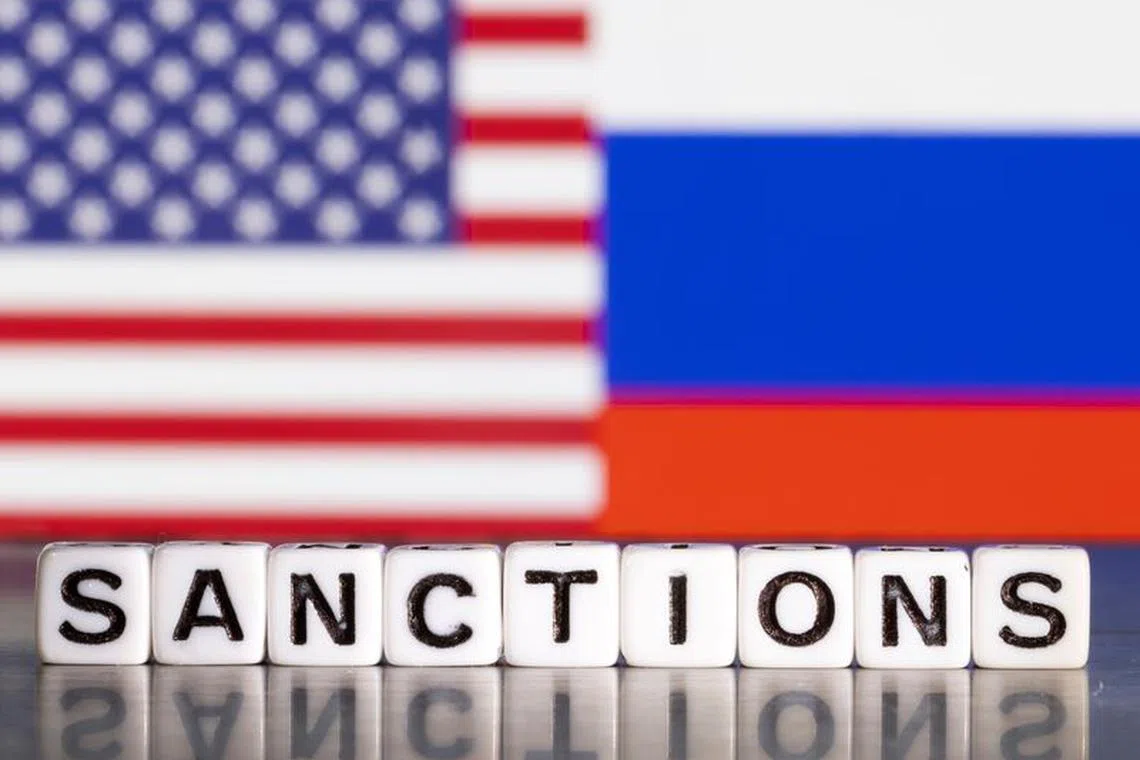 File photo: Plastic letters arranged to read \"Sanctions\" are placed in front the flag colors of U.S. and Russia in this illustration taken February 28, 2022. REUTERS/Dado Ruvic/Illustration/File photo