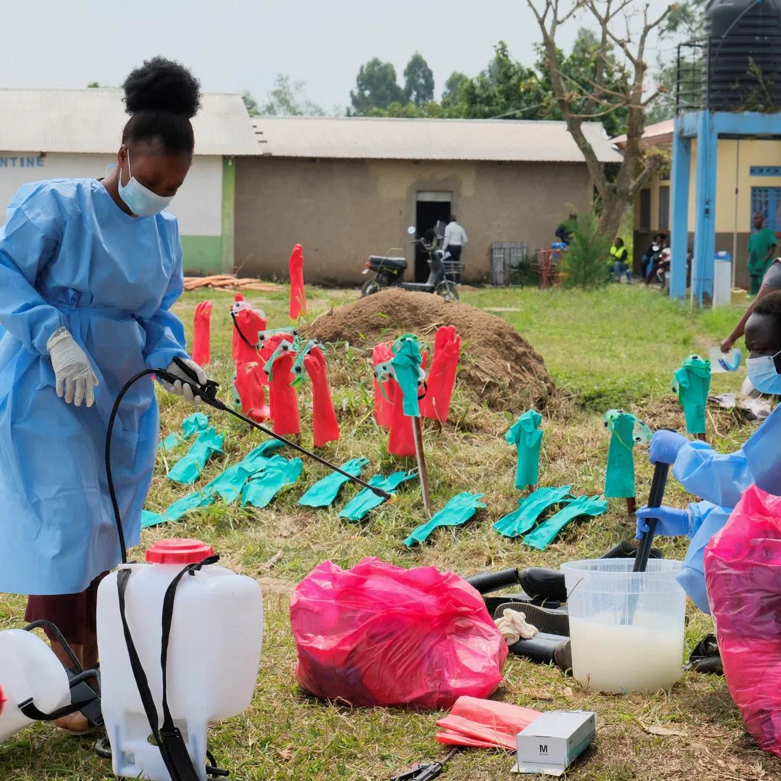 FILE PHOTO: Medical workers dressed in personal protective equipment (PPE) disinfect their equipment at an Ebola treatment centre during a ceremony to present recovery certificates to patients at the Rwambara General Reference Hospital in Bunia, eastern Democratic Republic of Congo, June 16, 2026. REUTERS/Gradel Muyisa Mumbere/File Photo