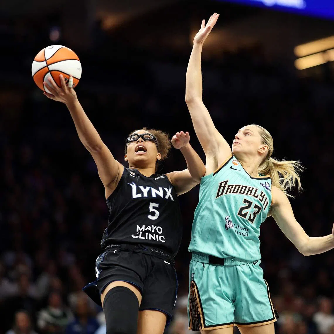 MINNEAPOLIS, MINNESOTA - SEPTEMBER 18: Olivia Miles #5 of the Minnesota Lynx draws a foul against Marine Johannes #23 of the New York Liberty in the fourth quarter at Target Center on September 18, 2026 in Minneapolis, Minnesota. The Liberty defeated the Lynx 93-81. NOTE TO USER: User expressly acknowledges and agrees that, by downloading and or using this photograph, User is consenting to the terms and conditions of the Getty Images License Agreement.   David Berding/Getty Images/AFP (Photo by David Berding / GETTY IMAGES NORTH AMERICA / Getty Images via AFP)