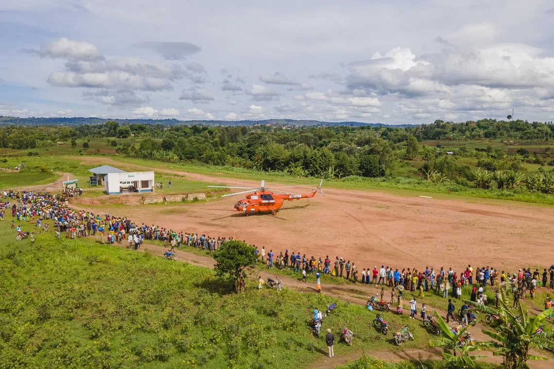 FILE PHOTO: A general view shows a United Nations Humanitarian Air Service (UNHAS) helicopter managed by the World Food Programme (WFP), painted in orange colour as part of efforts to improve safety of operations in the restive eastern Congo at the Mahagi airstrip in Ituri province of the Democratic Republic of Congo in this photograph released on April 20, 2023. World Food Programme/Handout via REUTERS