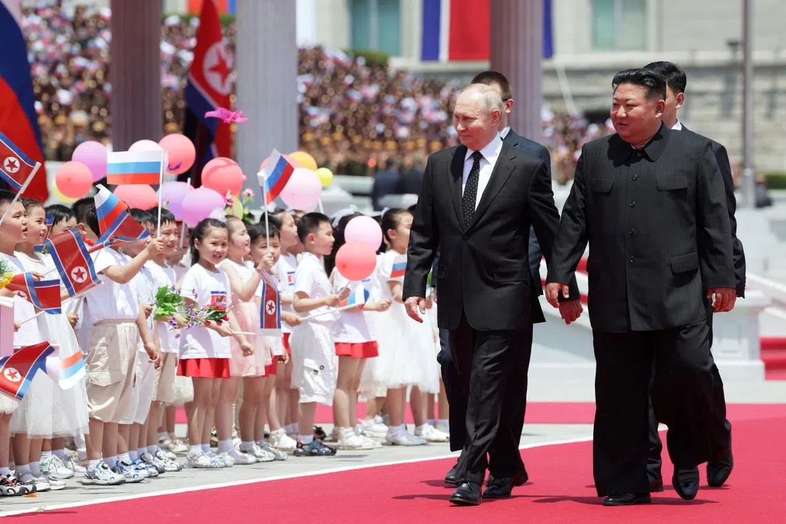 North Korea's leader Kim Jong Un (right) and Russian President Vladimir Putin attend a welcoming ceremony at Kim Il Sung Square in Pyongyang on June 19.