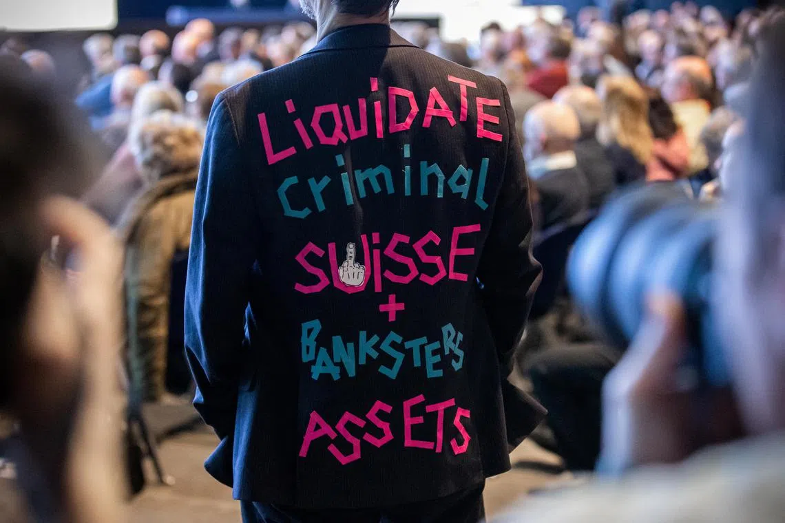 An unhappy shareholder wears a blazer with a text on its back during Credit Suisse's AGM on April 4, 2023.