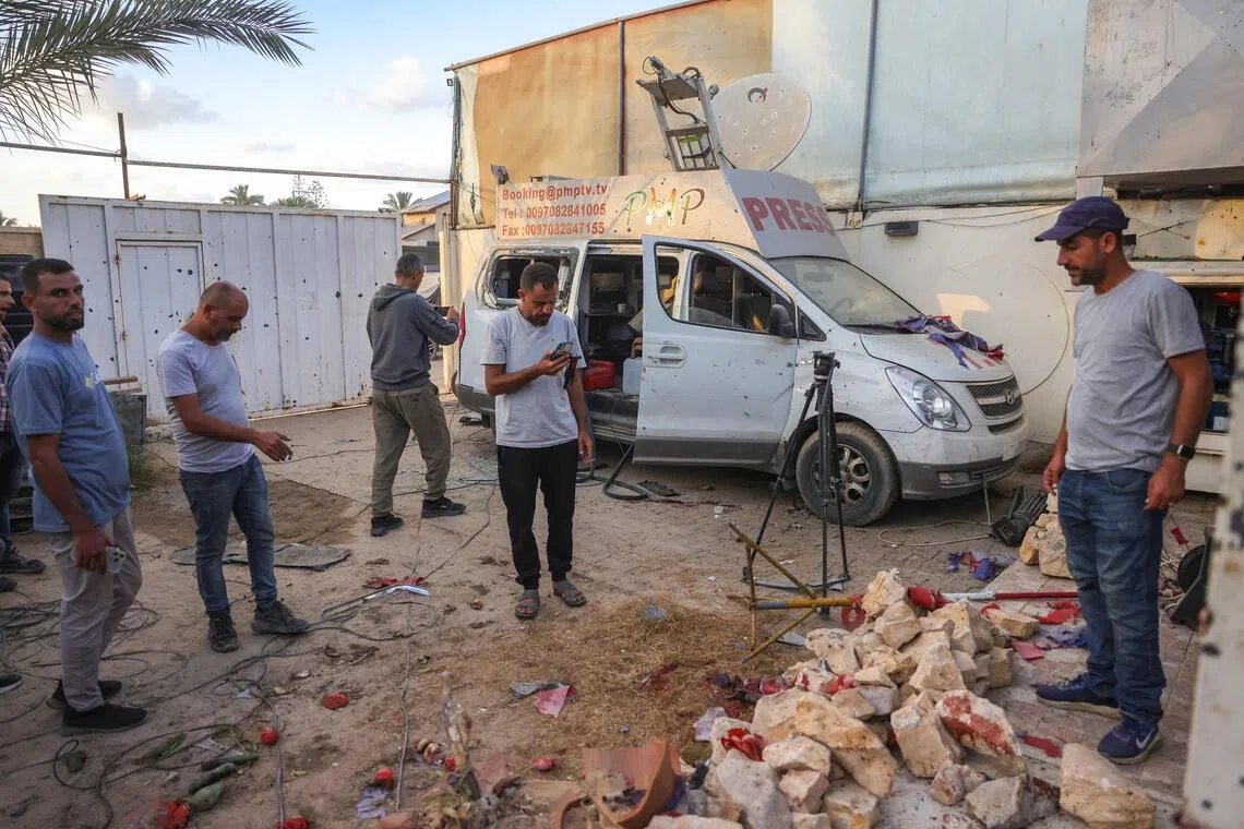 People inspect the damage following an Israeli strike that reportedly struck a house used by journalists in the Al-Zawayda city near Deir al-Balah, in the central Gaza on Oct 19, 2025.