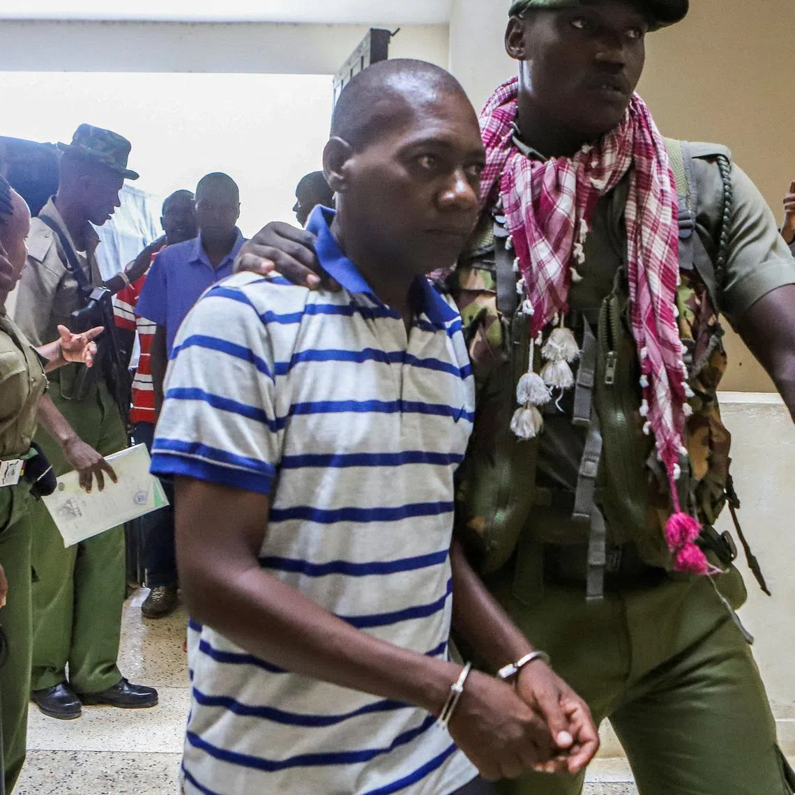 FILE PHOTO: Paul Mackenzie, a Kenyan cult leader accused of ordering his followers, who were members of the Good News International Church, to starve themselves to death in Shakahola forest, is escorted to the Malindi Law Courts in Malindi, Kilifi, Kenya January 17, 2024. REUTERS/Stringer/File Photo