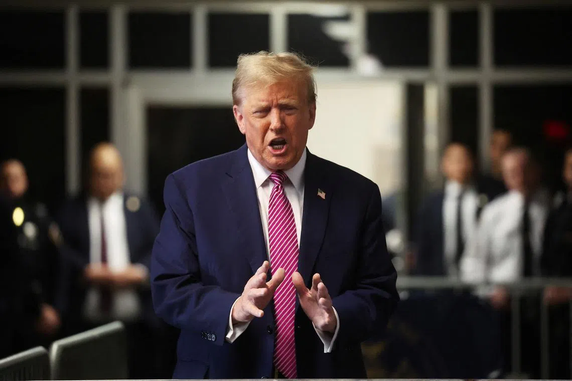 Former U.S. President Donald Trump speaks to the media as he enters Manhattan Criminal Court for his trial for allegedly covering up hush money payments in New York, U.S., April 19, 2024. Spencer Platt/Pool via REUTERS