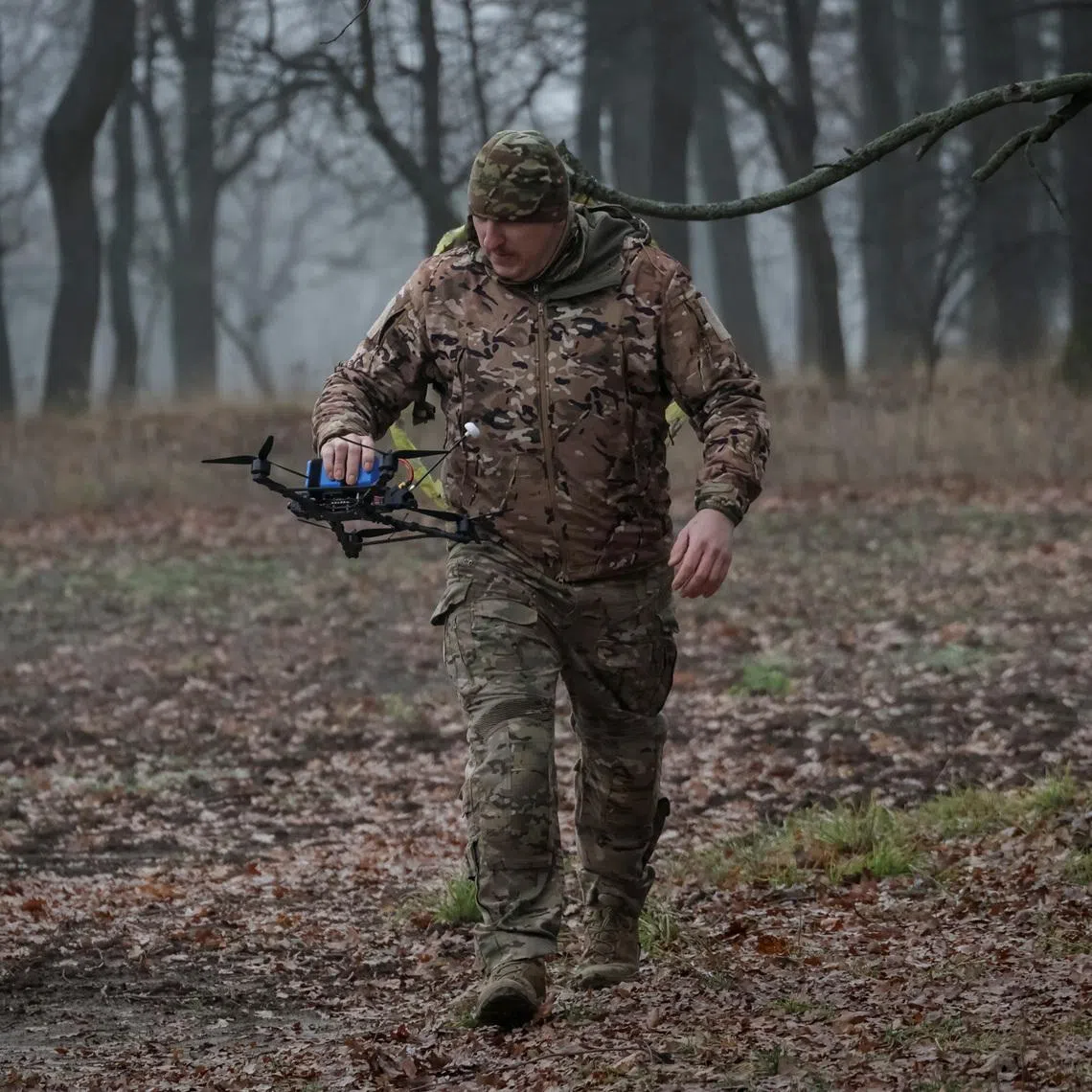A serviceman of the 58th Separate Motorized Infantry Brigade of the Ukrainian Armed Forces carries a FPV-drone with an AI-assisted targeting system, amid Russia's attack on Ukraine, in Kharkiv region, Ukraine November 26, 2025. REUTERS/Sofiia Gatilova