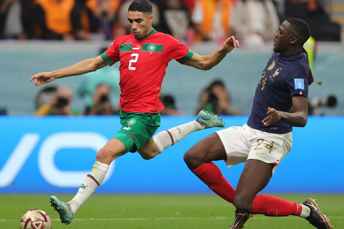 France defender Ibrahima Konate kept a close eye on Achraf Hakimi of Morocco during their World Cup semi-final match on Wednesday.