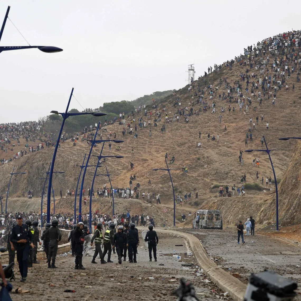 Moroccan security forces at the site of clashes with migrants gathering on a hilltop near Fnideq, on the Morocco-Spain border, on July 31.