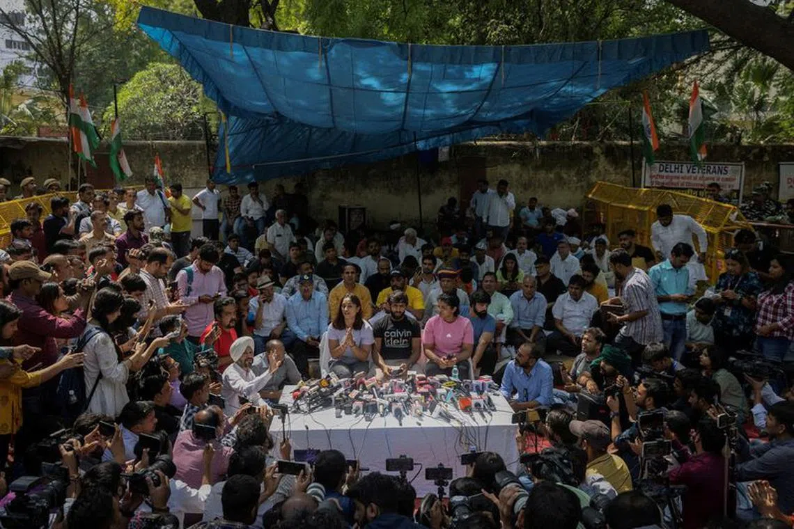 FILE PHOTO: Indian wrestlers Vinesh Phogat, Bajrang Punia, and Sakshi Malik address a news conference as they take part in a sit-in protest demanding arrest of Wrestling Federation of India (WFI) chief, who they accuse of sexually harassing female players, in New Delhi, India, April 24, 2023. REUTERS/Adnan Abidi/File Photo