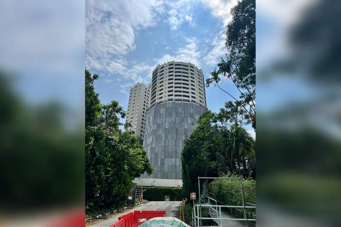 The main tower of Thomson View, the writer's old home, with tarpaulin cladding reaching ever higher, like a shroud being pulled up. 