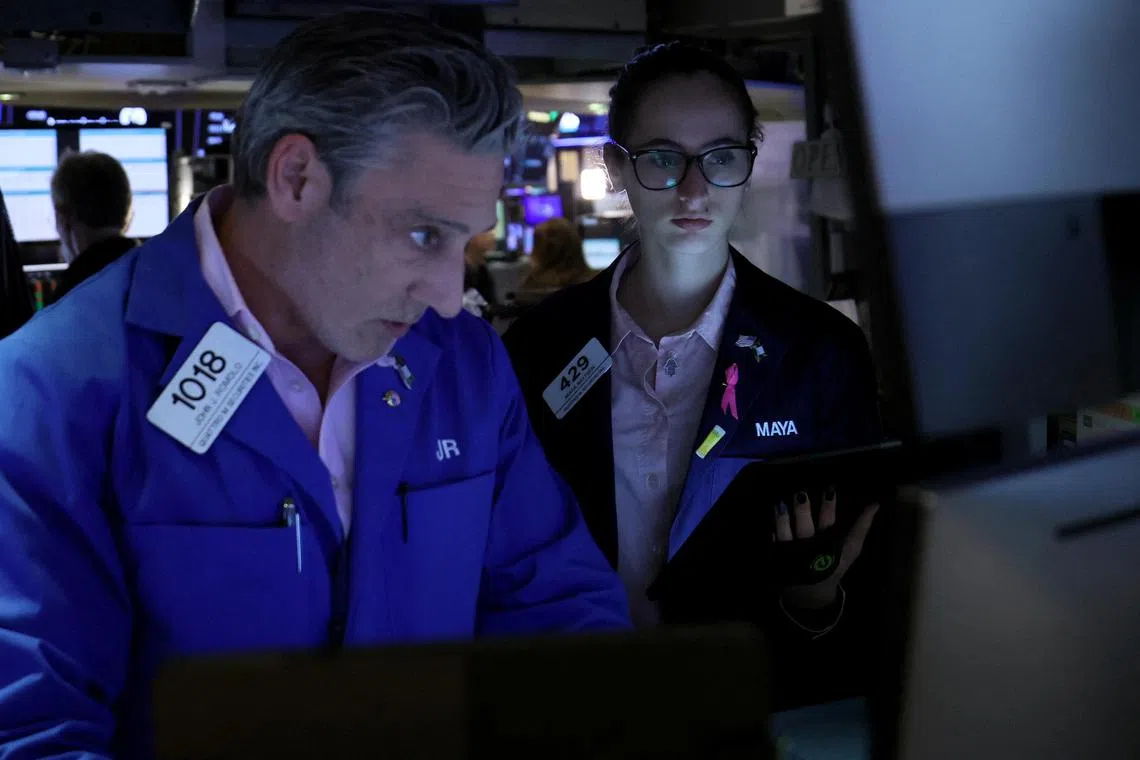 Traders work on the floor of the New York Stock Exchange, in New York City.