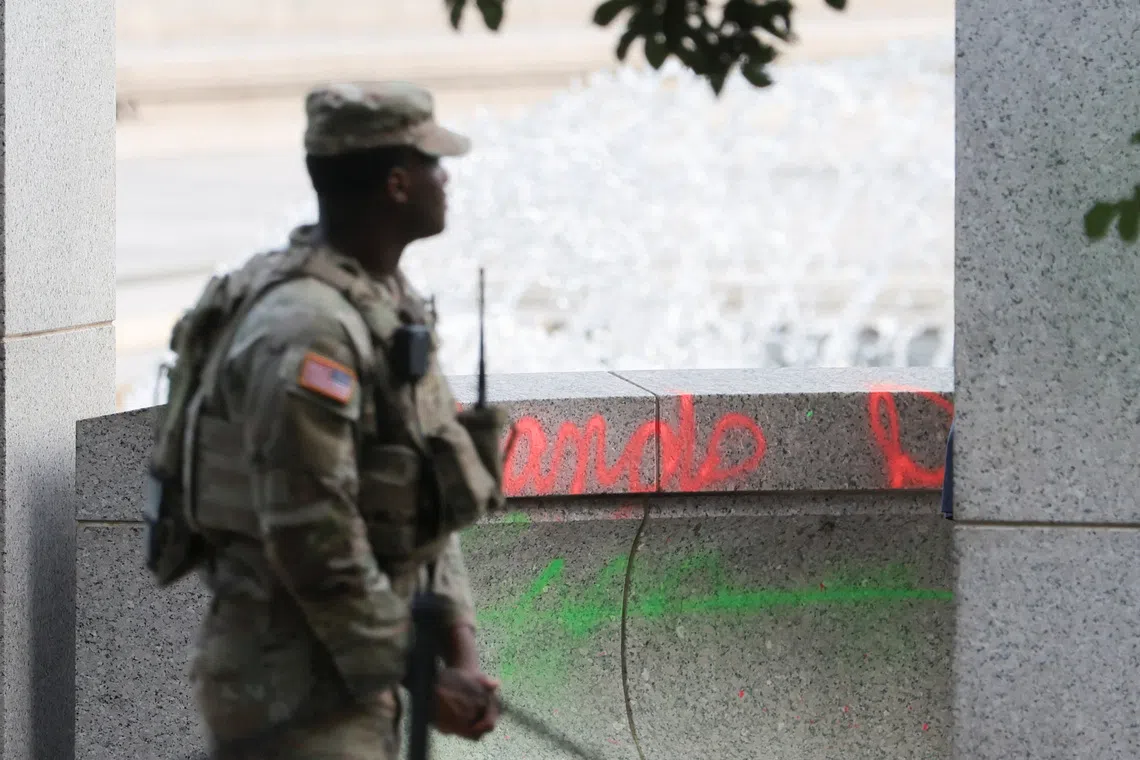 The fountain bubbled over with suds and someone painted “Clean hands Dirty $” on one surface, splattering the area with paint.