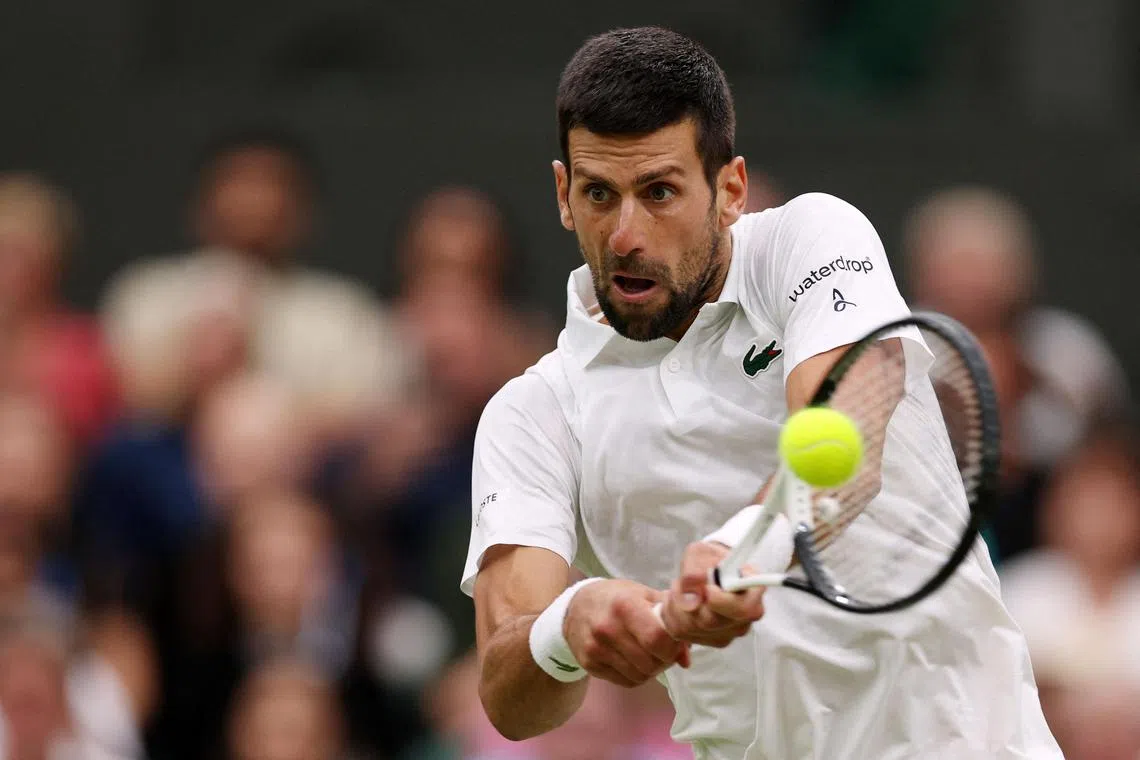 Novak Djokovic returning the ball to Italy's Jannik Sinner during their Wimbledon semi-final clash, which the Serbian won in straight sets.