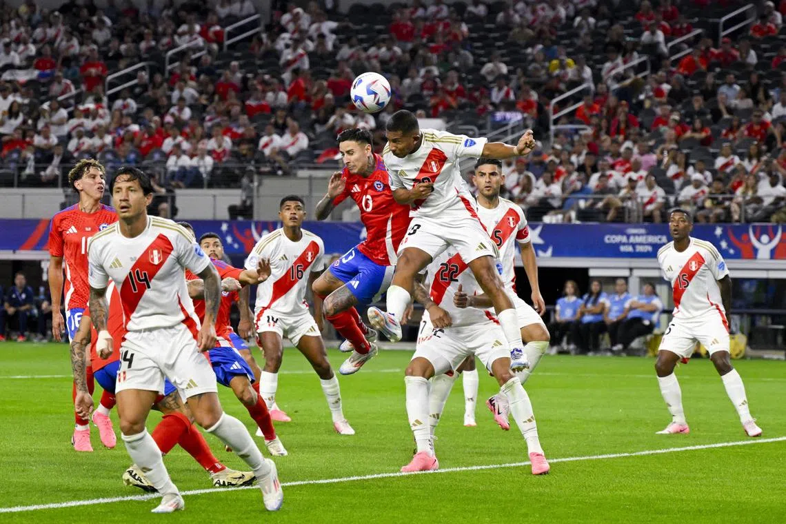 Chile midfielder Erick Pulgar (No. 13) and Peru forward Edison Flores fighting for the ball in their Copa America match at AT&T Stadium on Jun 21, 2024 in Arlington, Texas.