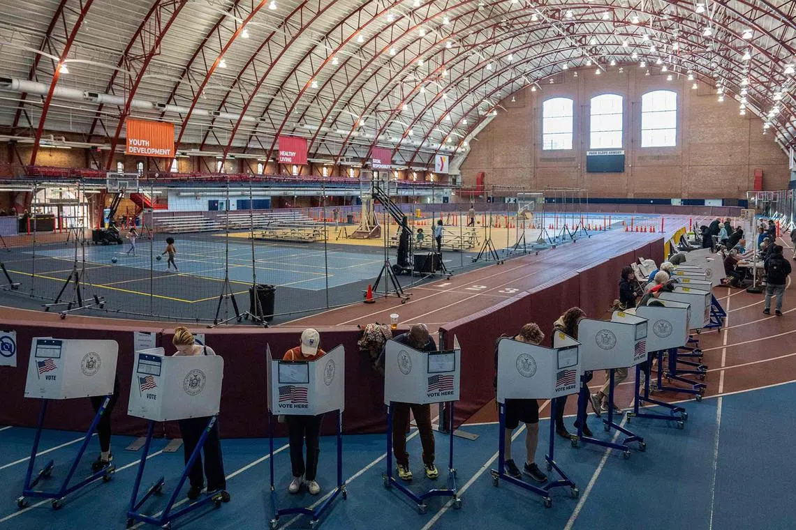 TOPSHOT - People vote at a polling station in the Brooklyn borough of New York City on Election Day, November 5, 2024. (Photo by David Dee Delgado / AFP)