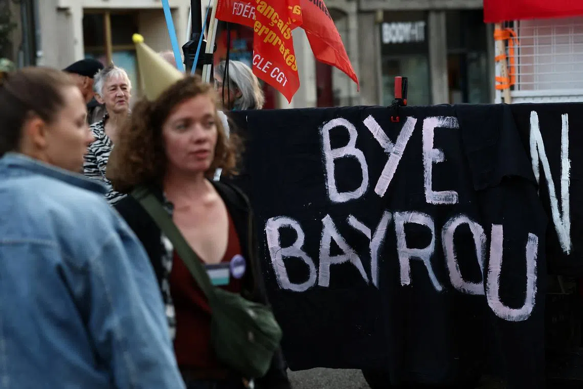 Protesters hold a banner which reads "Bye Bayrou" as they gather for a "Bayrou’s farewell party" protest in front of the city hall in Nantes after French Prime Minister Francois Bayrou failed to secure a majority from MPs in a confidence vote during an extraordinary session at the National Assembly, France, September 8, 2025. REUTERS/Stephane Mahe/File Photo