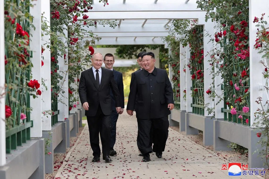 FILE PHOTO: Russia's President Vladimir Putin and North Korea's leader Kim Jong Un react during a walk in the garden of the Kumsusan Guesthouse in Pyongyang, North Korea in this image released by the Korean Central News Agency June 20, 2024. KCNA via REUTERS/File Photo