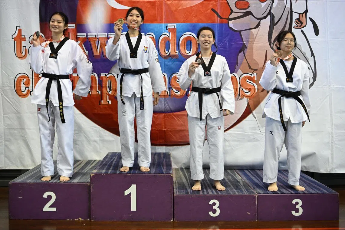 The medallists for the National School Games (NSG) B division taekwondo (kyorugi) girls black belt under 56kg category, with Megan Tsu in first place, Shermaine Ang in second place, Isabella Leow and Levon Tan in third place. 