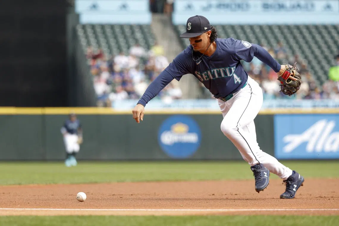 FILE PHOTO: Sep 19, 2024; Seattle, Washington, USA; Seattle Mariners third baseman Josh Rojas (4) recovers a ground ball after committing an error against the New York Yankees during the first inning at T-Mobile Park. Mandatory Credit: Joe Nicholson-Imagn Images