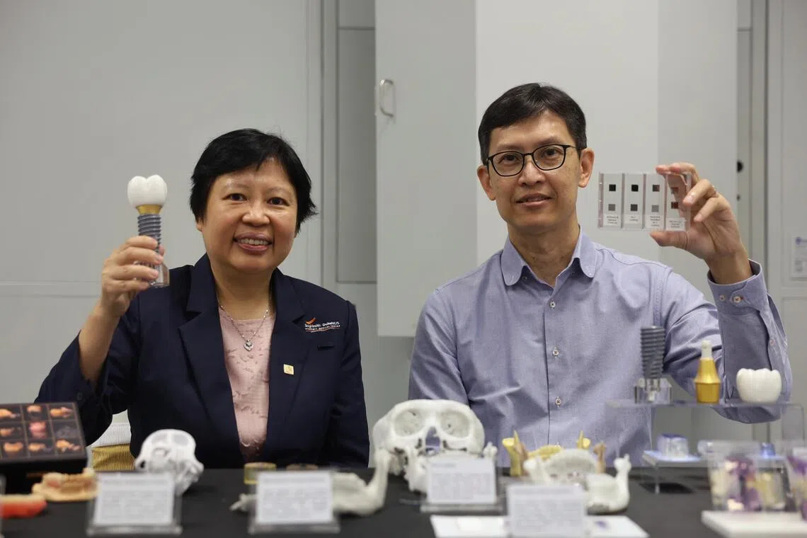 (Left to right) CEO National Dental Centre Singapore Professor Goh Bee Tin and Professor Ng Kee Woei, Chair, School of Materials Science & Engineering holding up a model of a dental implant and a sample of a nanocomposite coating during the opening of the NTI-NTU corporate laboratory on April 20, 2026.