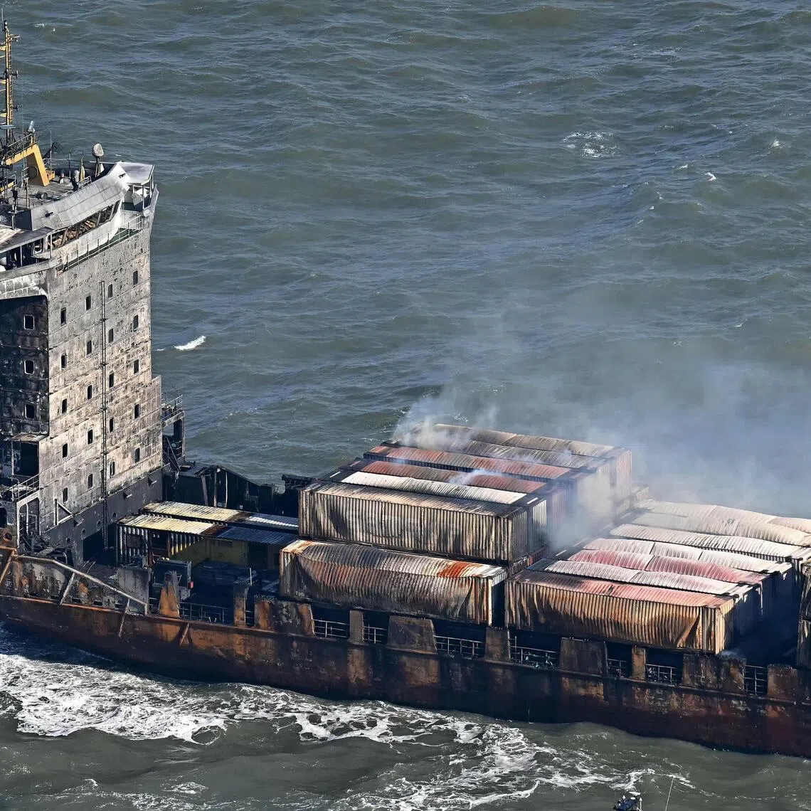 Smoke rising from damaged containers on the deck of the Solong cargo ship, off the UK coast, in March 2025, after it collided a tanker carrying aviation fuel. A Filipino member of the Solong crew died in the incident.