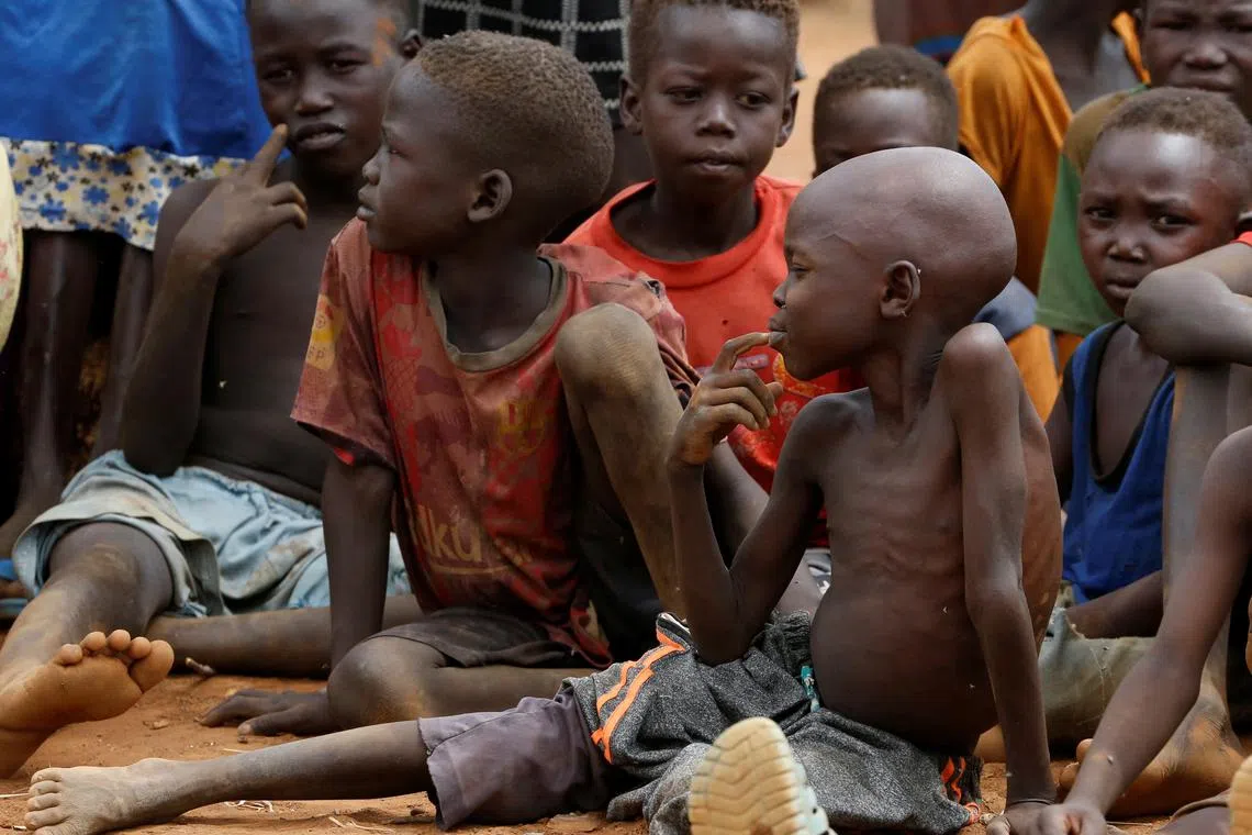 FILE PHOTO: Orphans and children separated from their parents in Kadugli gather to eat boiled leaves for food at an IDP Camp within Sudan People's Liberation Movement-North (SPLM-N) controlled area in Boram County, Nuba Mountains, South Kordofan, Sudan June 22, 2024. REUTERS/Thomas Mukoya/File Photo