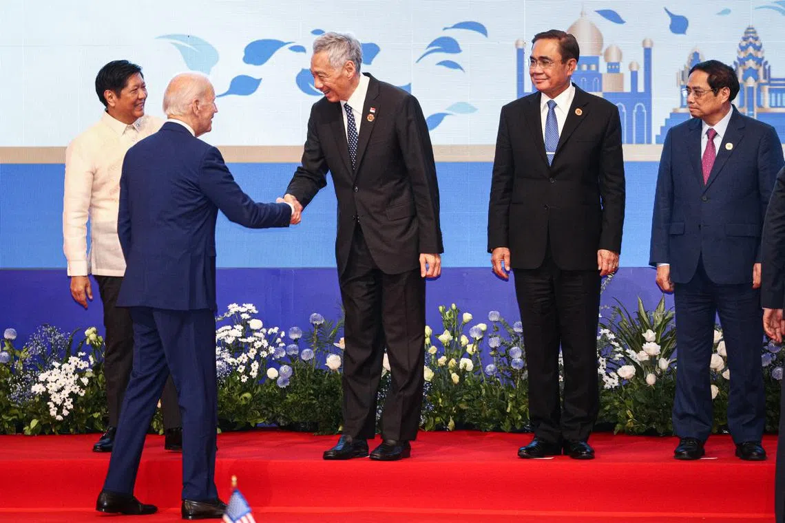 PM Lee Hsien Loong greeting US President Joe Biden at the Asean summit in Phnom Penh on Nov 12.