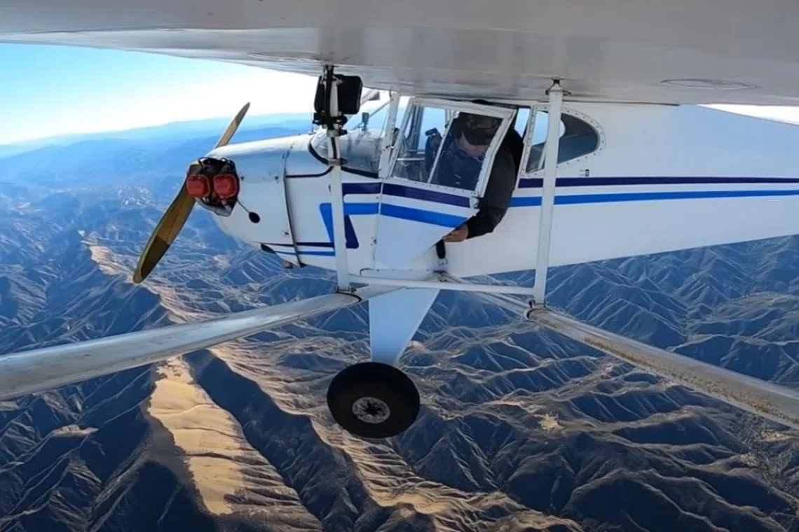 Dramatic footage shows Trevor Jacob ejecting from the single engine plane and parachuting into a forest in California.