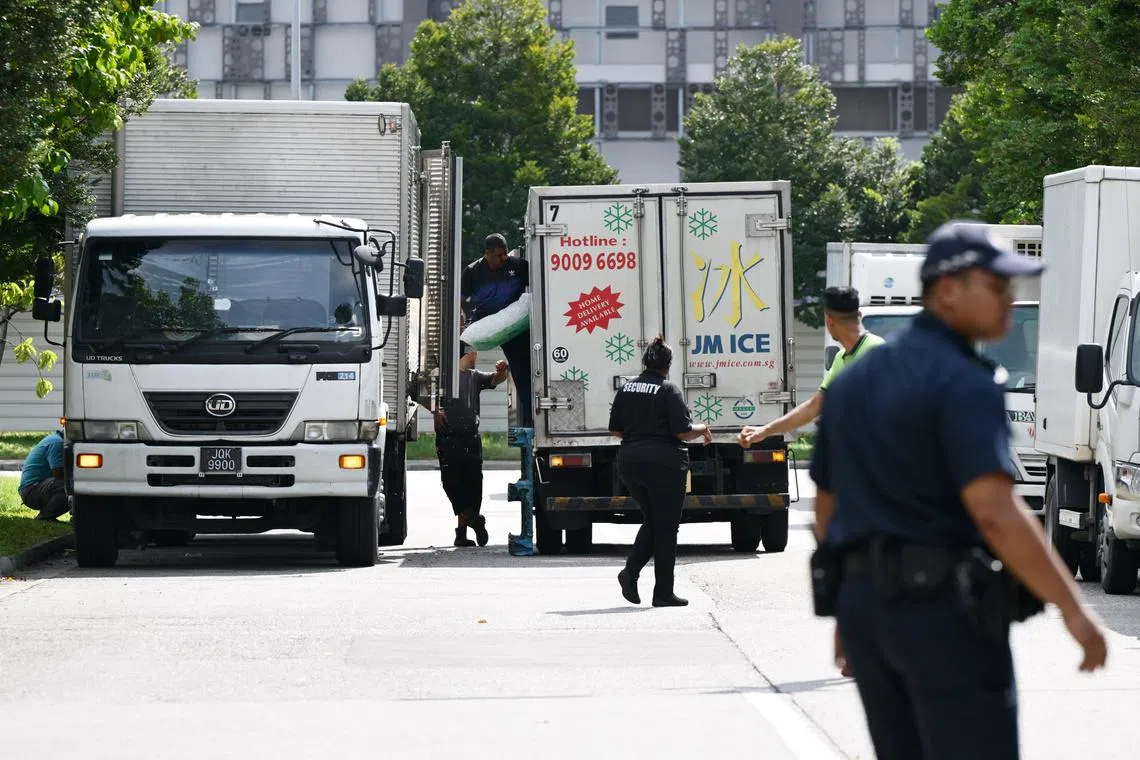 Workers from Jurong Marine Cold Storage that operates at 11 Jurong Fishery Port Road transporting ice from a supplier into vehicles waiting near their factory.