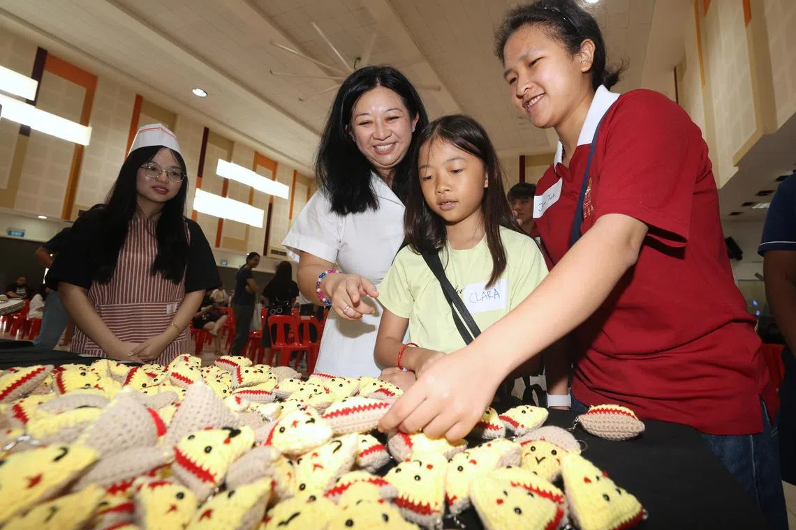 Pasir-Ris Punggol GRC MP Yeo Wan Ling (second from left) giving out crocheted "positivity pizzas" to youths on March 23.