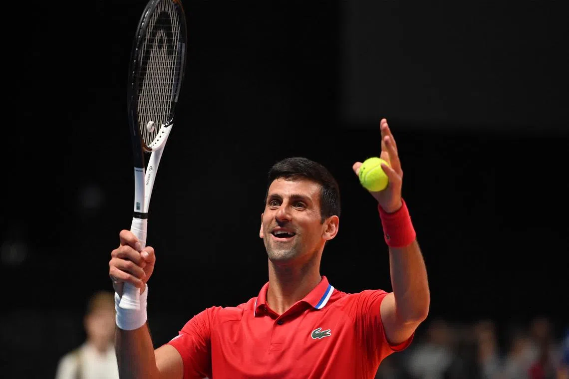 Serbia's Novak Djokovic celebrates defeating Austria's Sebastian Ofner, during a World Tennis League exhibition match in Dubai.