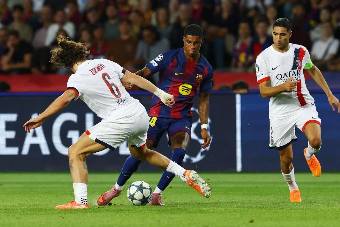 Barcelona's Marcus Rashford taking on Paris Saint-Germain players in their Champions League clash.