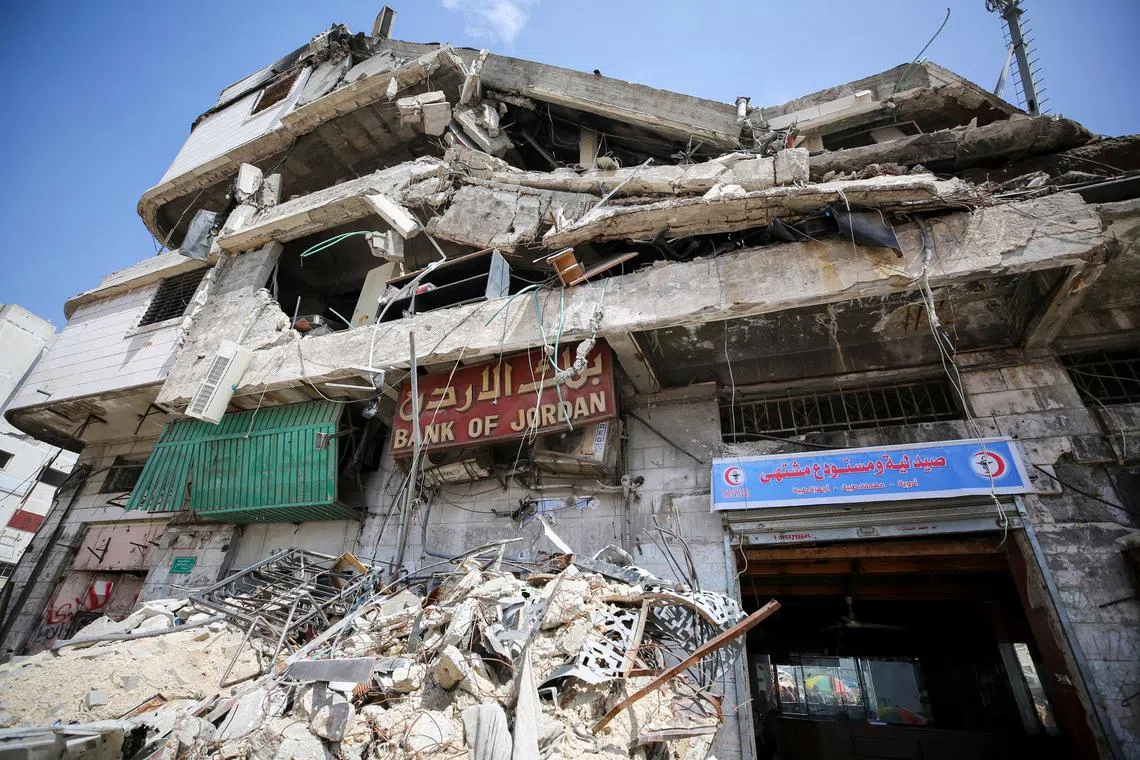 A building housing Bank of Jordan stands in ruins after it was destroyed in an Israeli strike, amid a cash crunch caused by the destruction and closure of banks, as conflict between Israel and Hamas continues, in Gaza City May 5, 2024. REUTERS/Dawoud Abu Alkas
