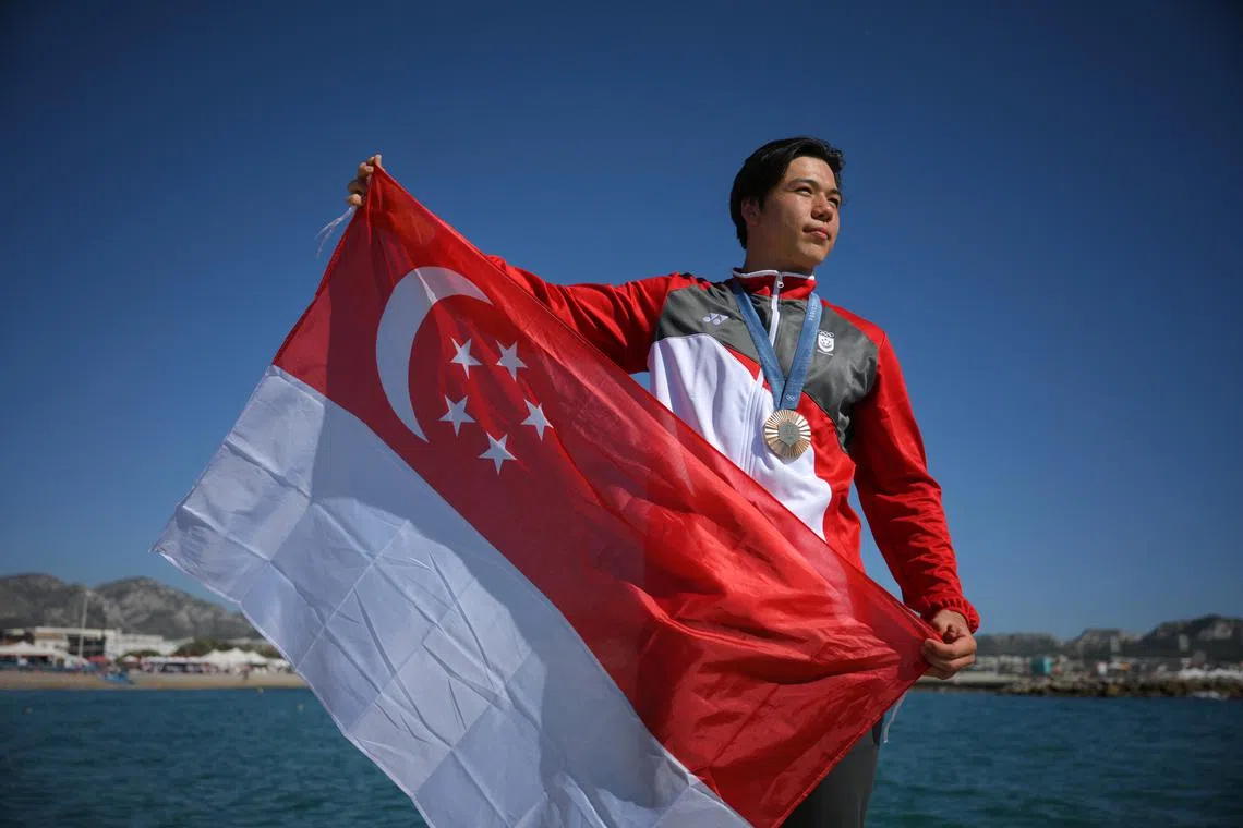 Singaporean kitefoiler Maximilian Maeder poses with his bronze medal after the Paris 2024 Olympics Men’s Kite final at the Marseille Marina on August 9, 2024.