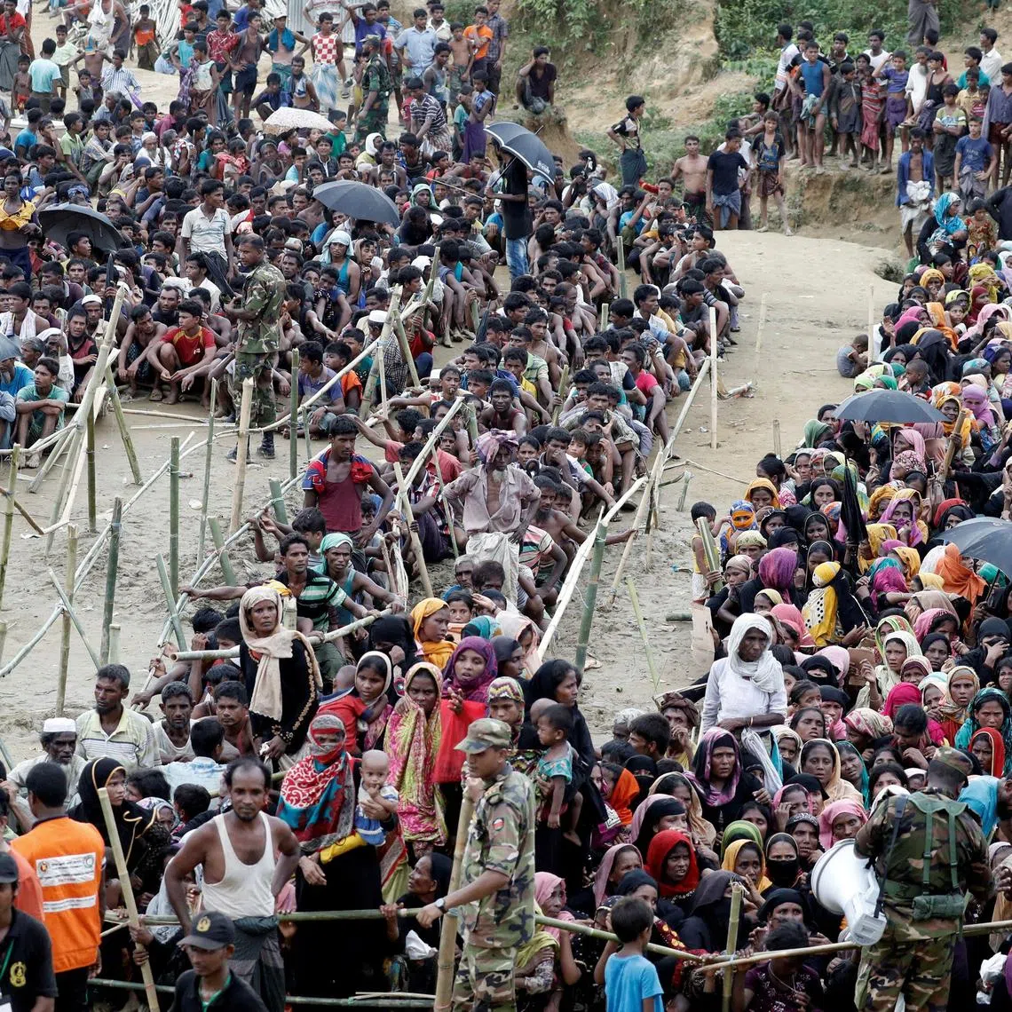 Rohingya refugees queue for aid at Cox's Bazar, Bangladesh, on Sept 26, 2017. 