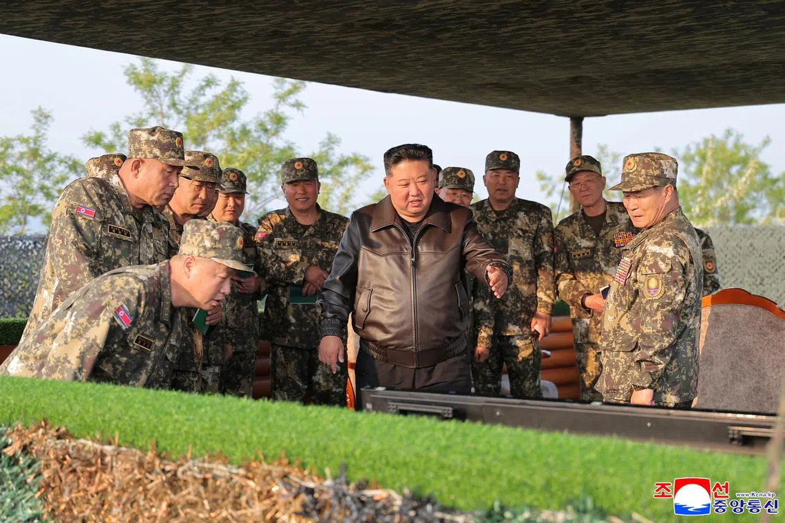 North Korean leader Kim Jong Un (centre) inspecting an artillery drill in this handout picture released on May 30.