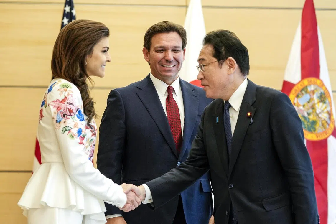 Florida Governor Ron DeSantis (centre) introduces his wife, Casey, to Japanese Prime Minister Fumio Kishida.
