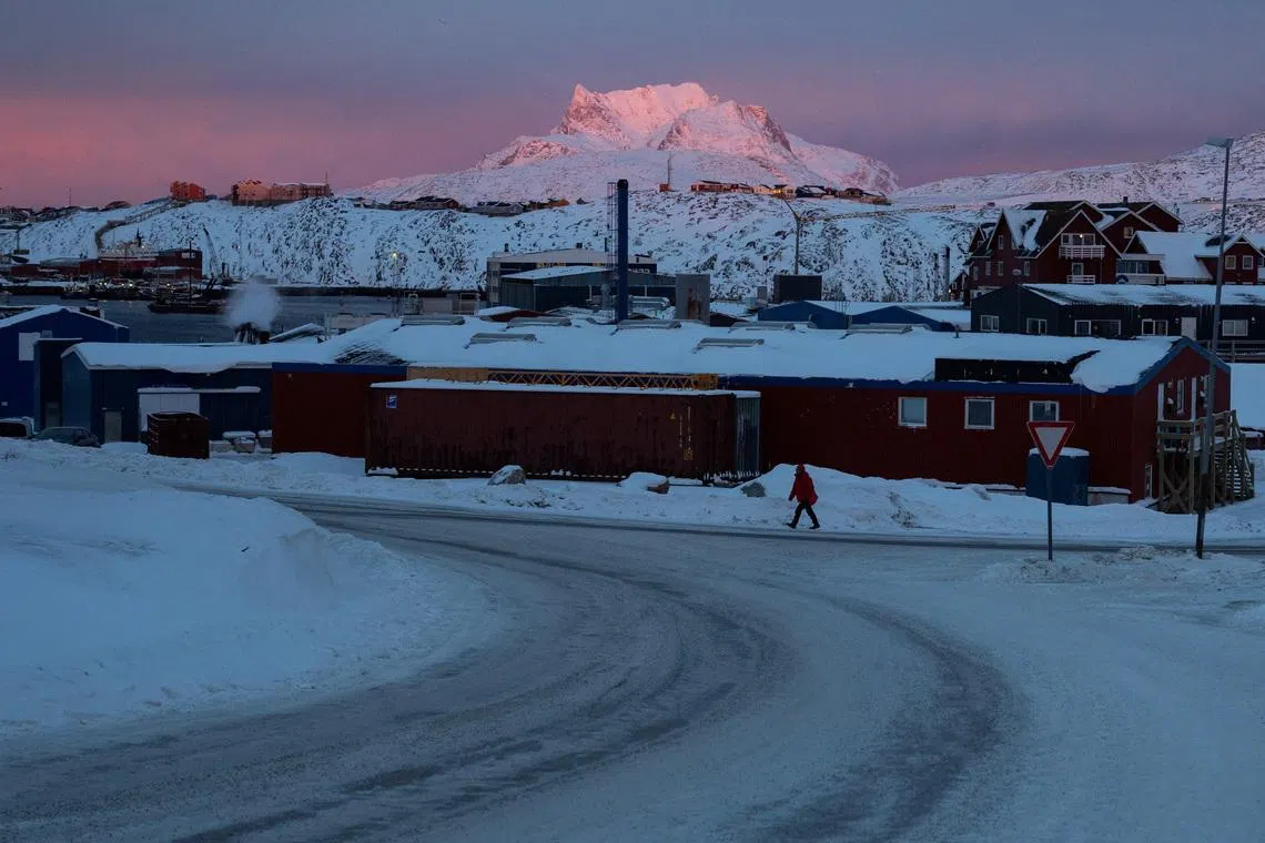 A person walks along a street as the sun sets near the U.S. Consulate in Nuuk, Greenland, January 21, 2026. REUTERS/Marko Djurica