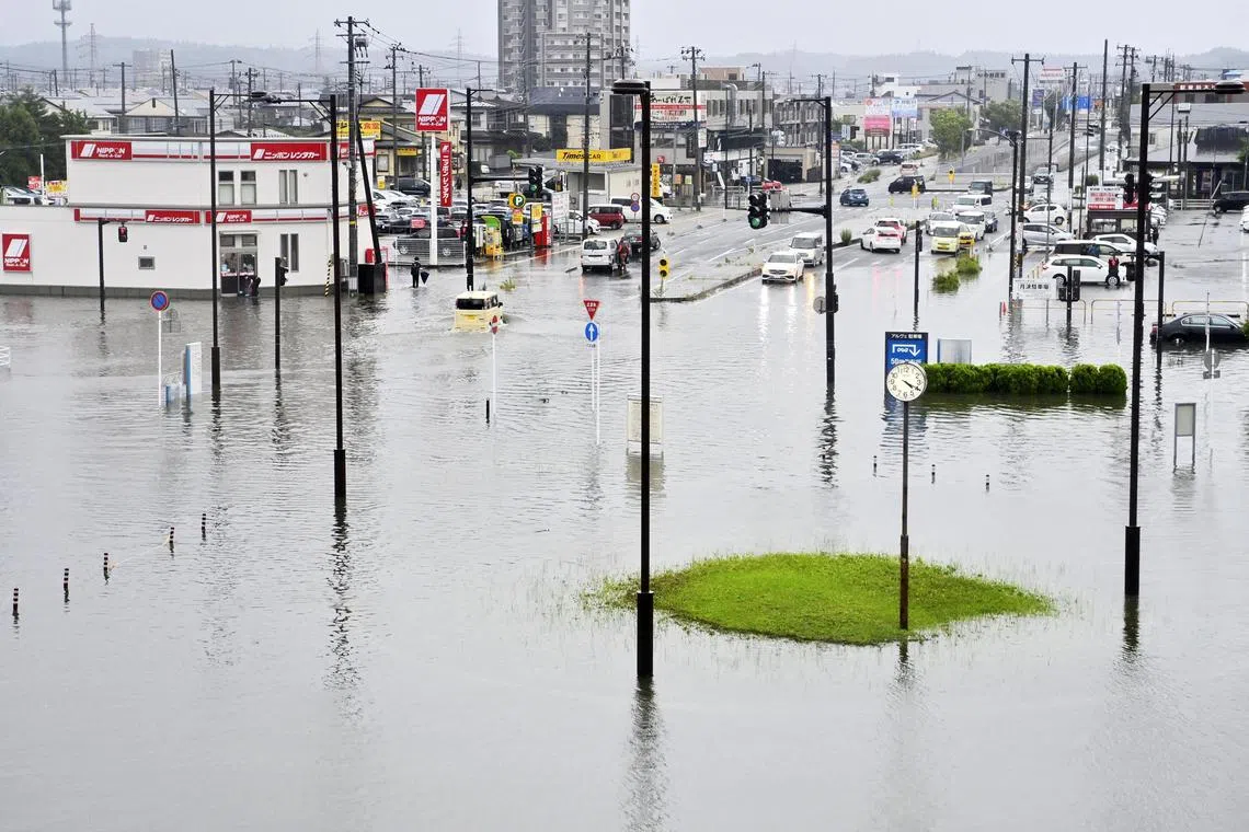 Flooded roads in front of Akita station following heavy rain in Akita, northeastern Japan, on July 15, 2023.
