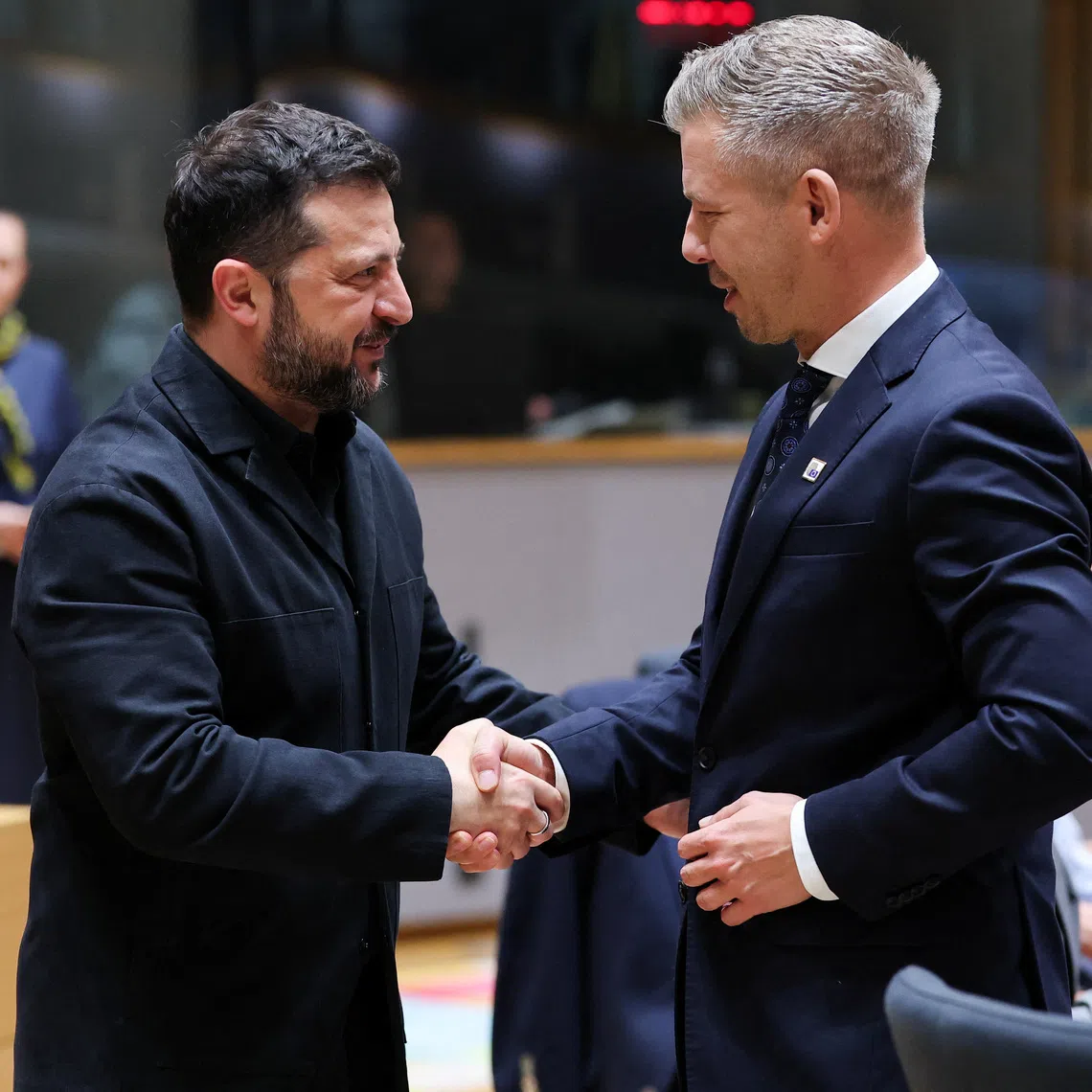 Ukraine's President Volodymyr Zelenskiy and Hungary's Prime Minister Peter Magyar greet each other during a European Union leaders summit in Brussels, Belgium October 16, 2026.  REUTERS/Stephanie Lecocq