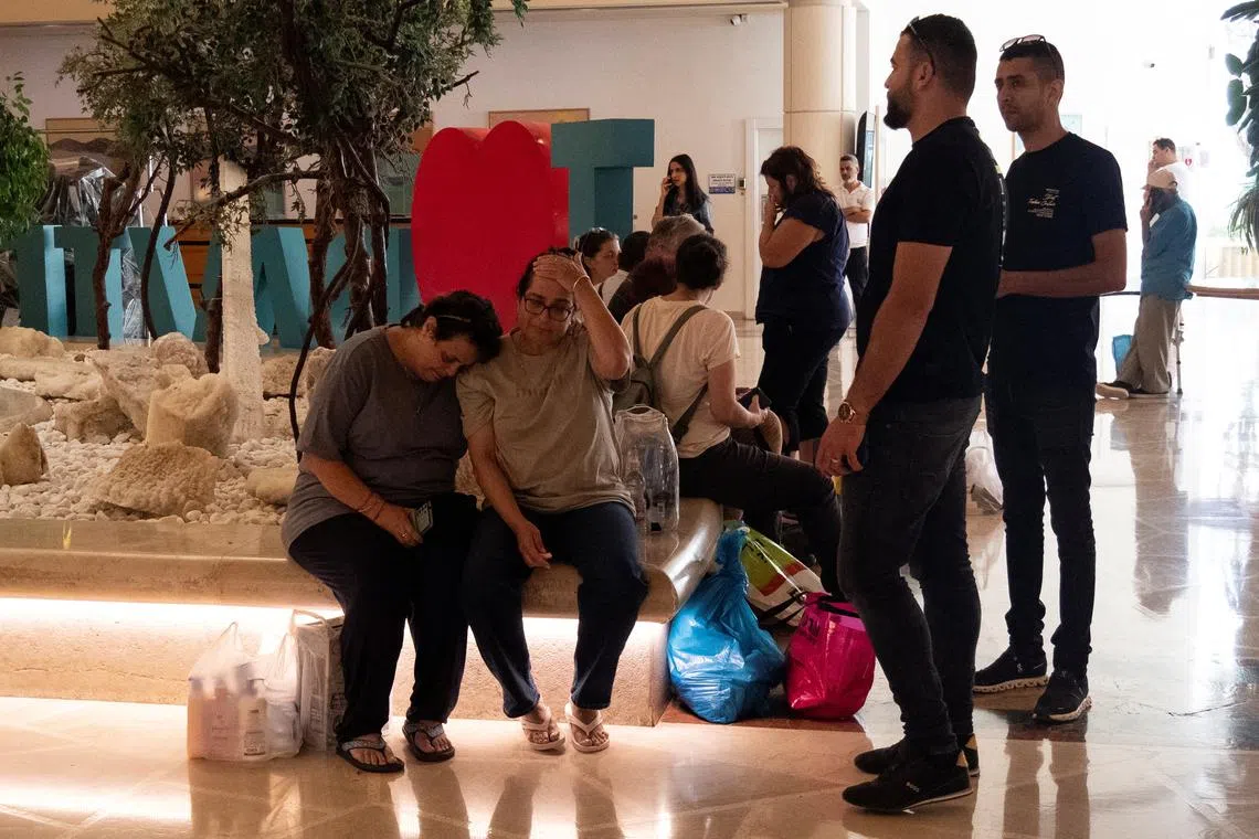 Survivors of the Hamas attack on southern Israel supporting one another after being evacuated to a hotel in Ein Bokek, Israel, on Oct 11.