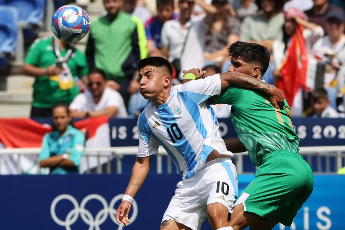 Paris 2024 Olympics - Football - Men's Group B - Argentina vs Iraq - Lyon Stadium, Dcines-Charpieu, France - July 27, 2024.
Thiago Almada of Argentina in action with Mustafa Saadoon of Iraq. REUTERS/Nir Elias