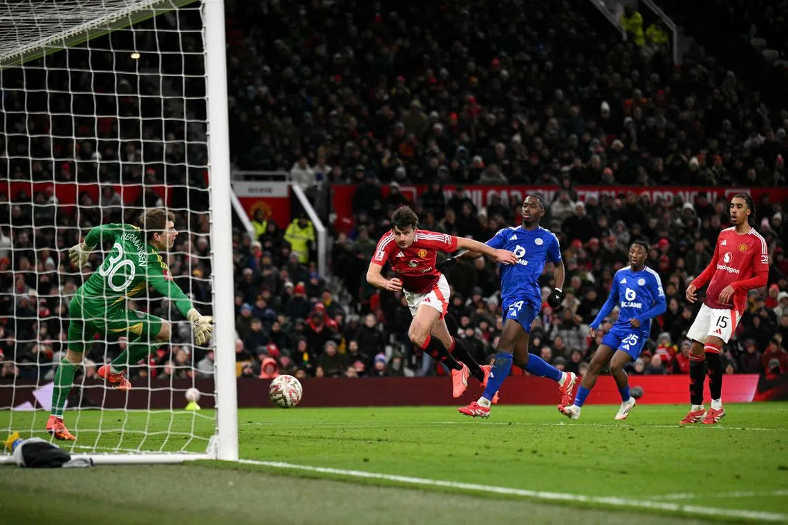 Manchester United's English defender #05 Harry Maguire scores the team's second goal during the English FA Cup fourth round football match between Manchester United and Leicester City at Old Trafford in Manchester, north west England, on February 7, 2025. (Photo by Oli SCARFF / AFP) / RESTRICTED TO EDITORIAL USE. No use with unauthorized audio, video, data, fixture lists, club/league logos or 'live' services. Online in-match use limited to 120 images. An additional 40 images may be used in extra time. No video emulation. Social media in-match use limited to 120 images. An additional 40 images may be used in extra time. No use in betting publications, games or single club/league/player publications. / 