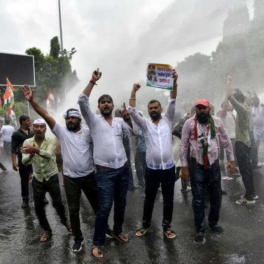 Police personnel use a water cannon to disperse India’s Opposition Congress party supporters shouting slogans against India’s Chief Election Commissioner Gyanesh Kumar, demanding his resignation during a protest in Patna on Sept 25.