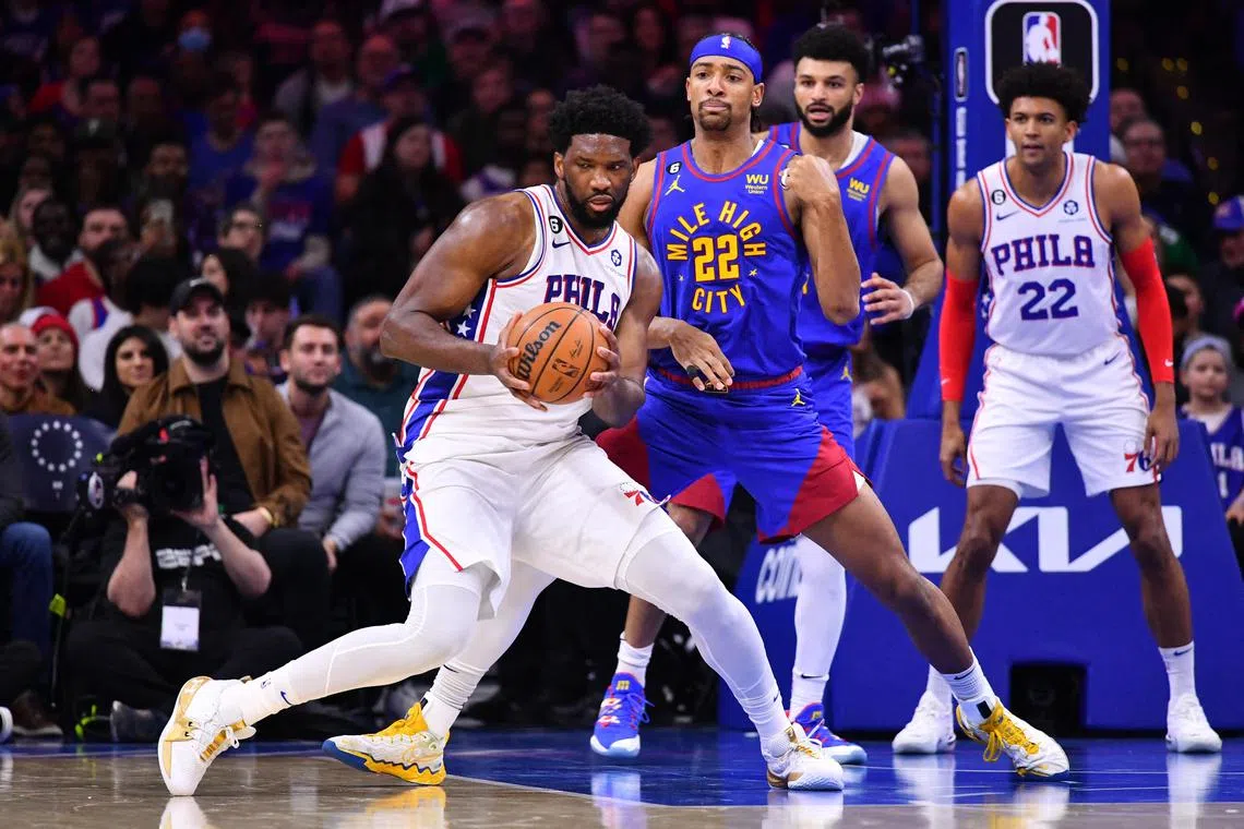Philadelphia 76ers centre Joel Embiid (front) controls the ball against Denver Nuggets forward Zeke Nnaji (No. 22) in the second quarter of their NBA clash on Saturday. 