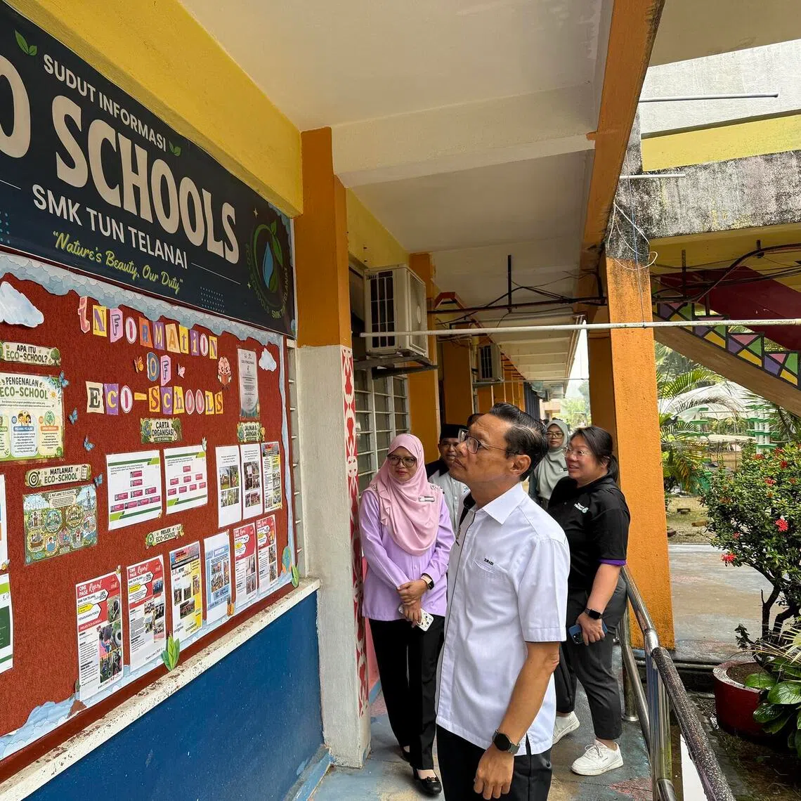 Terengganu deputy education director Wan Zuraidi Wan Zaid checks on the progress of Tun Telanai Secondary’s Eco-School programme on Sept 15.