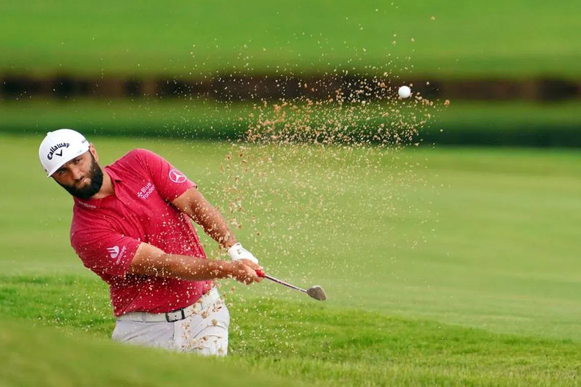 FILE PHOTO: Aug 27, 2023; Atlanta, Georgia, USA; Jon Rahm plays a shot from a bunker on the eighth hole during the final round of the TOUR Championship golf tournament at East Lake Golf Club./John David Mercer-USA TODAY Sports/File Photo