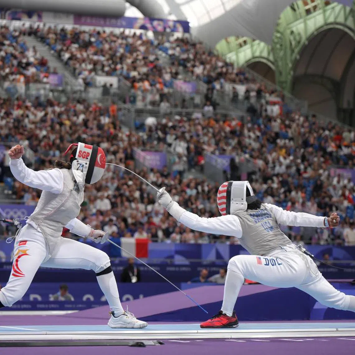 Singaporean fencer Amita Berthier (left) lost 15-13 to the United States' world No. 9 Lauren Scruggs at the Grand Palais in Paris, France on July 28.