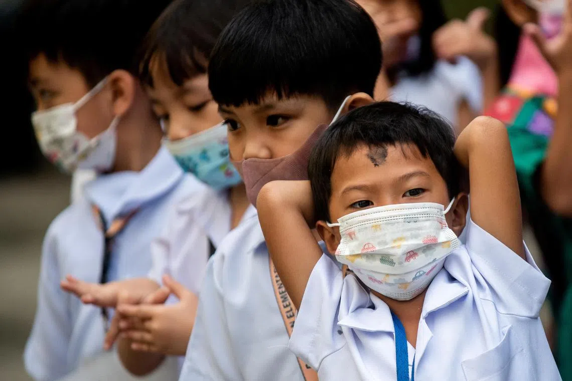 A student with ashes on his forehead stretches his arms, during Ash Wednesday, at an elementary school in Paranaque City, Metro Manila, Philippines, February 22, 2023. REUTERS/Lisa Marie David