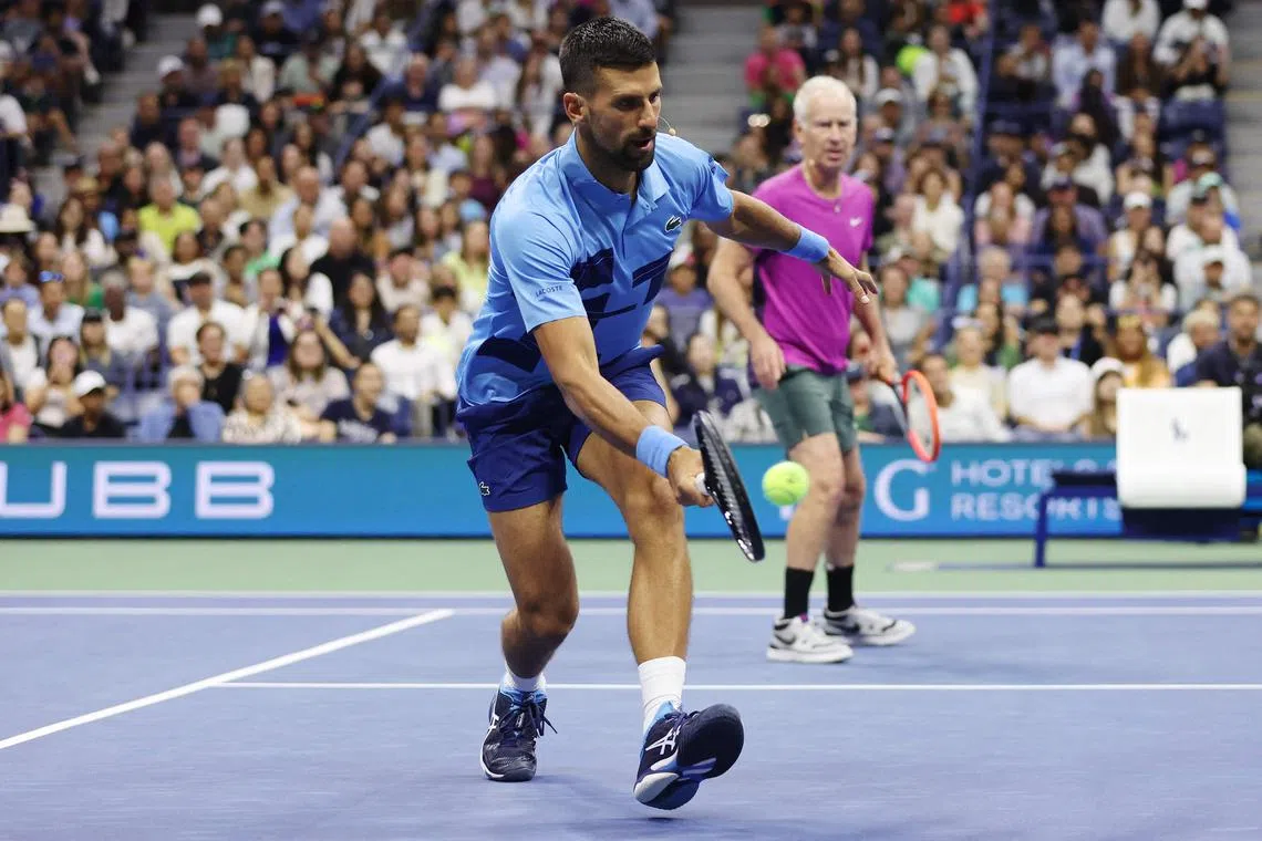John McEnroe and Novak Djokovic play against Andre Agassi and Carlos Alcaraz (not pictured) during the Stars of the Open exhibition match before the US Open.